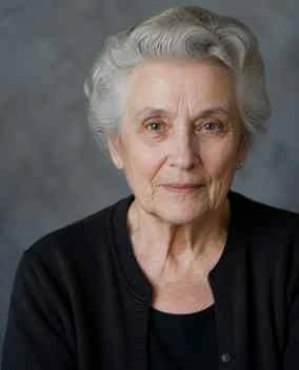 AI-generated portrait of an elderly woman, artificially degraded — blurred and noisy — before restoration